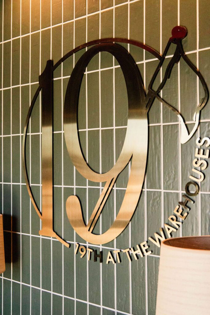 19th at the Warehouses - Indoor Golf & Bar metal logo on wall