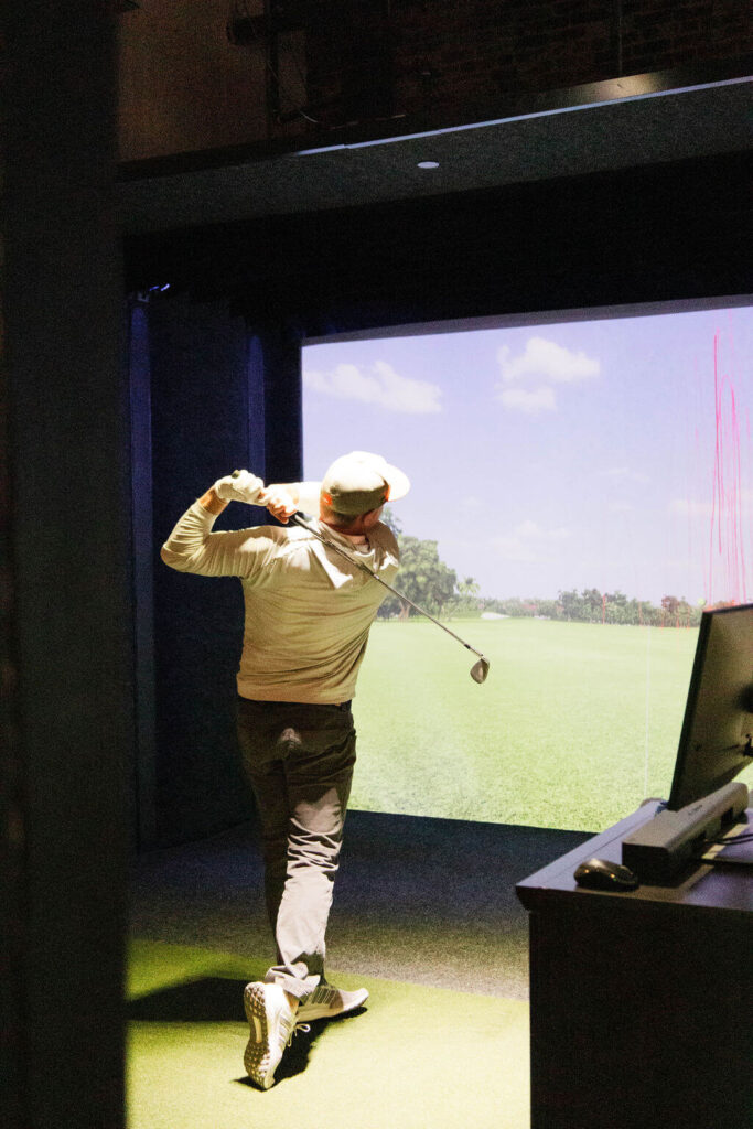golfer practicing using FullSwing golf simulator